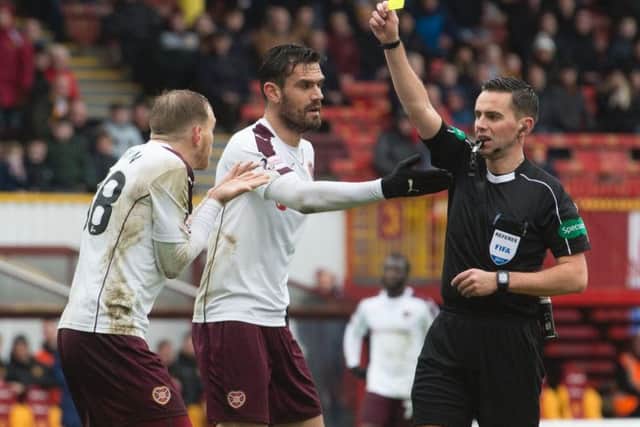 Hearts midfielder Malaury Martin is wrongly yellow carded by Andrew Dallas