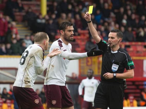 Hearts midfielder Malaury Martin is wrongly yellow carded by Andrew Dallas