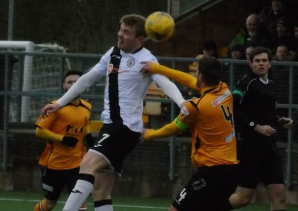 Edinburgh City striker Lewis Allan wins a header against Annan. Pic: Alex Drysdale