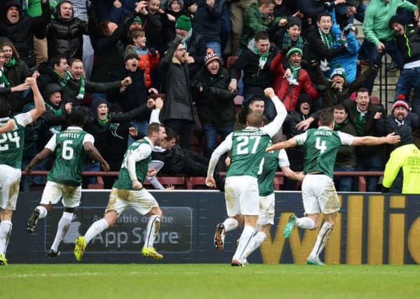 Hibs players and fans rush to celebrate with Paul Hanlon after his dramatic late equaliser at Tynecastle last year