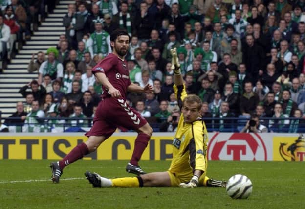 Paul Hartley flicks the ball past Zbigniew MaBkowski for the opening goal of the 2006 semi-final. Picture: Donald MacLeod