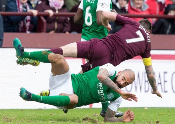 Hearts' Jamie Walker is tackled by Liam Fontaine