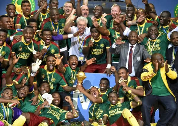 Arnaud Djoum, top left, celebrates Cameroon's AFCON success