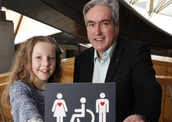 Grace Warnock and Iain Gray MSP with her disabled toilet sign. Picture: Andrew Cowan/Scottish Parliament