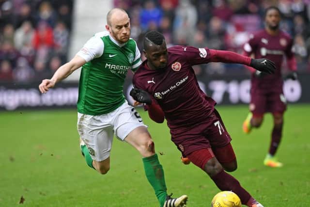 David Gray challenges Hearts' Esmael Goncalves in Sunday's cup match The tie will be replayed after a 0-0 draw. Picture: SNS
