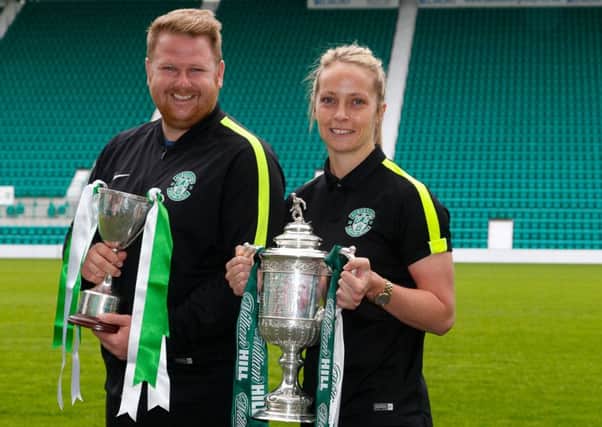 Manager of Hibs Ladies team Chris Roberts with Hibs Ladies centre half Joelle Murray holding the Ladies League cup and the Scottish Cup