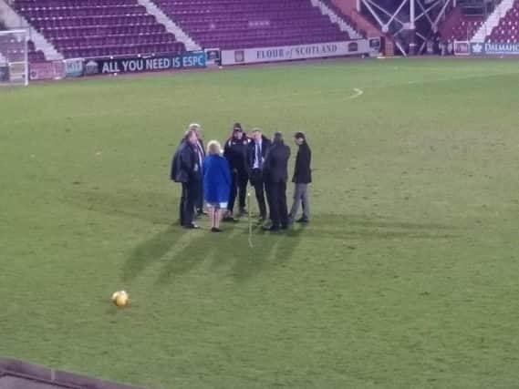 Ann Budge, Craig Levein, Ian Cathro and Scot Gardiner meet groundstaff to discuss the possible replacement of the Tynecastle pitch
