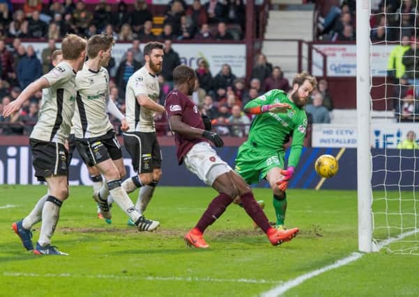 Hearts star Arnaud Djoum scores the equalising goal past Owain Fon Williams while the Inverness defenders are left stranded