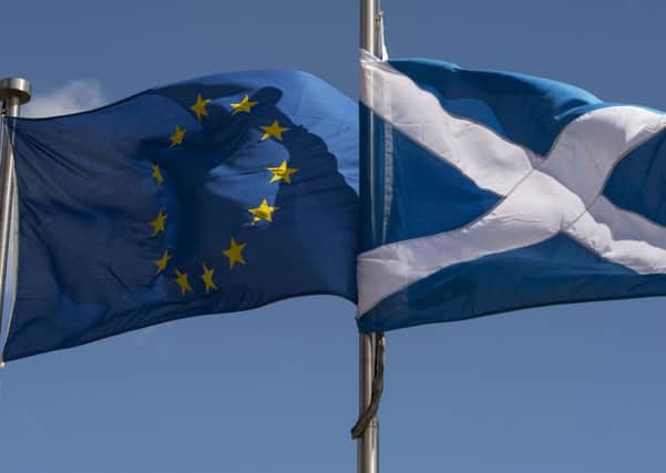 AScottish Saltire and a European Union flag flying in front of the Scottish Parliament building in Edinburgh. Picture: AFP PHOTO / OLI SCARFFOLI SCARFF/AFP/Getty Images