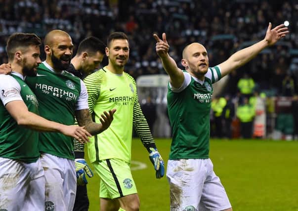 David Gray leads his team around Easter Road after their stirring derby victory but he agrees with Neil Lennon that league form has been inconsistent and that promotion back to the top flight remains the number one priority
