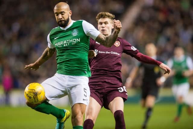 Currie challenges Hibs Liam Fontaine for the ball in the derby replay
