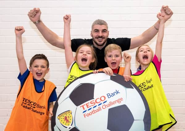 Hearts star Callum Paterson met youngsters, from left, Ewan Campbell, Lauren Dobie, Rory Topping and Skye Valentine during the Tesco Bank Football Challenge at Queensferry Primary School