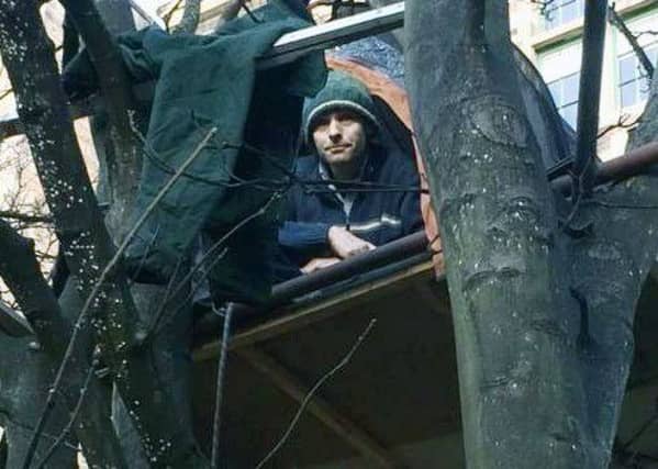 A man has spent 24 hours up a tree during a protest against plans for a £65m hotel in the heart of Edinburgh's Old Town. Picture: BBC