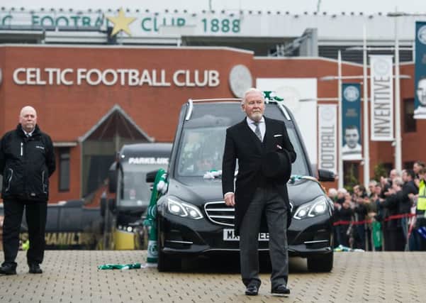 Fans pay their respects as Tommy Gemmell's funeral cortege stops at Celtic Park. Picture: John Devlin