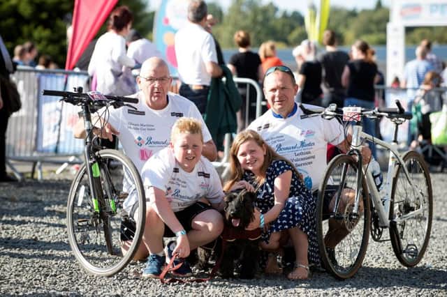 Reg and Barry Chisholm  joined here by Barrys children Aaron, 14, and Abbie, 12, and Hamish the dog. Picture: Warren Media