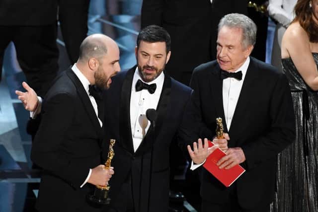 La La Land producer Jordan Horowitz, left, announces the actual Best Picture winner as Moonlight after a presentation error with host Jimmy Kimmel and actor Warren Beatty onstage during the 89th Annual Academy Awards. Picture: Getty