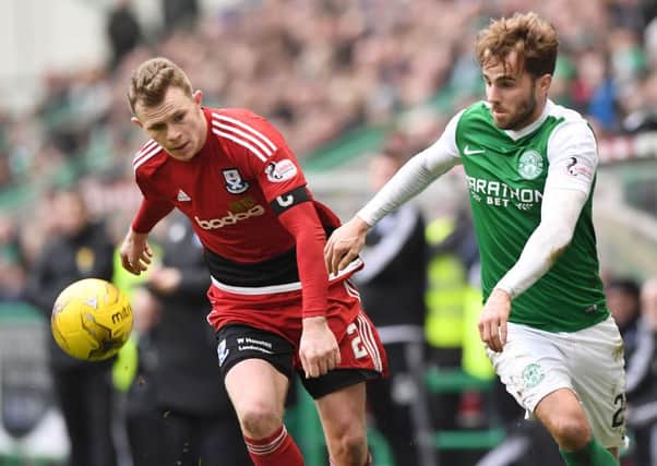 Ayr's Nicky Devlin battles for the ball against Hibs' Andrew Shinnie. Picture: SNS/Alan Harvey
