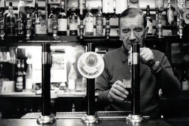 Willie Ross pours a half pint of ale at the bar. Picture: Copyright Len Cumming