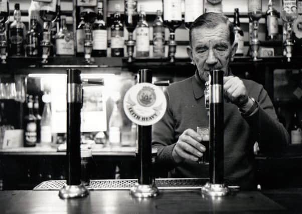 Willie Ross pours a half pint of ale at the bar. Picture: Copyright Len Cumming
