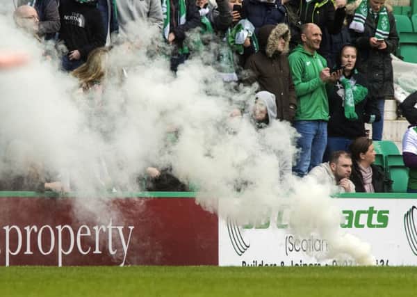 Supporters set off a flare at Easter Road in the William Hill Quarter Final. Picture; SNS