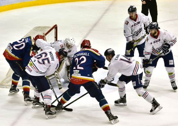Taylor MacDougall (No.22) scores the Capitals' only goal against Dundee, supported by Jared Staal, left. Pic: Jan Orkisz/SMP