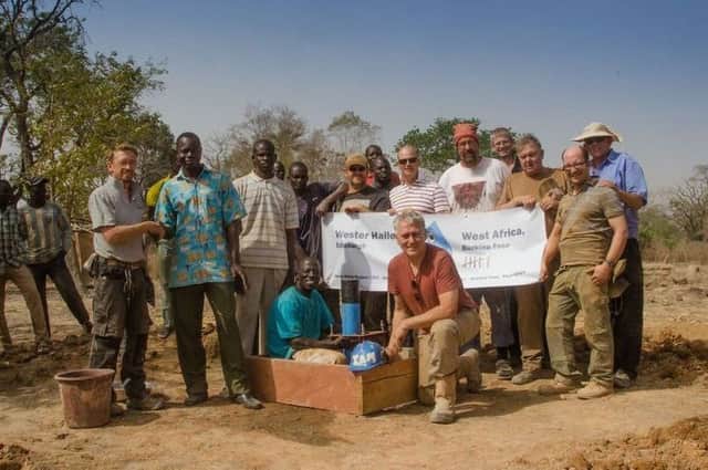 Ian Stirrat, front centre, with his team from Wester Hailes and villagers in Burkino Faso.
