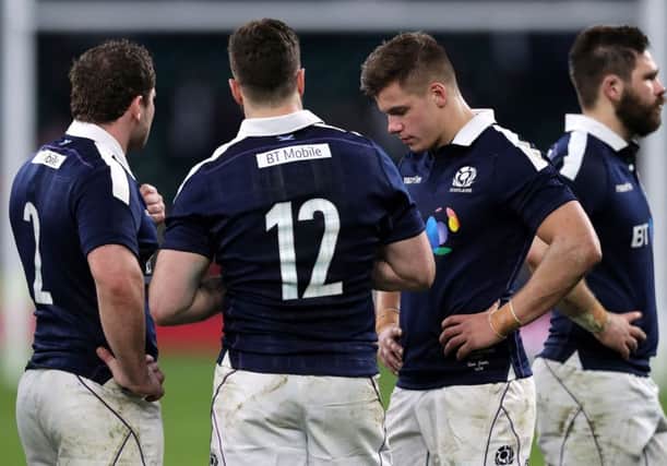 Scotland's Fraser Brown (left), Alex Dunbar (centre) and Huw Jones (right) appear dejected after the final whistle during defeat by England. Pic: PA