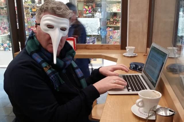 Gerry Farrell dons a carnival mask to write his column in Venice