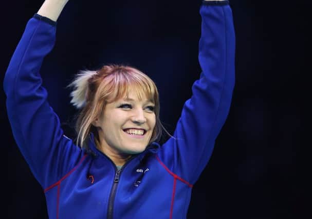 Elise Christie celebrates on the podium after clinching the women's overall title at the World Short Track Championships in Rotterdam. Picture: Dean Mouhtaropoulos/Getty Images