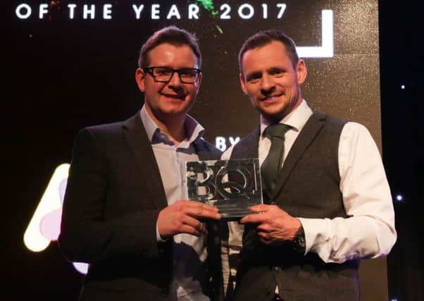 Shot Scope founder David Hunter, left, receives his award from We Are Boutique director Simon Bollon