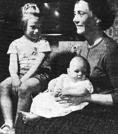 Mrs Cornelius at home with Alison (5) and her sister Elizabeth (4 months)

1962