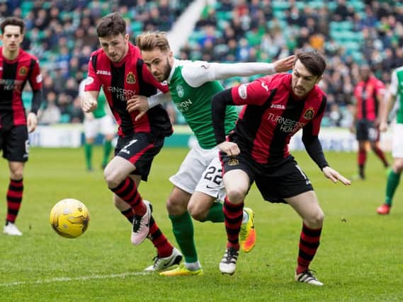 Hibs Andrew Shinnie battles his way past Dumbarton's Calum Gallagher (left) and David Smith