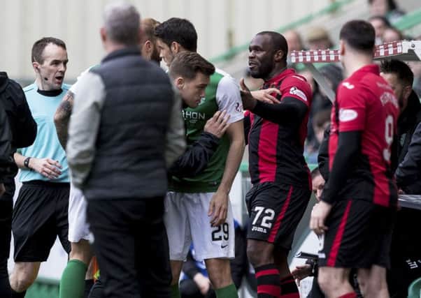 Christian Nade was involved in a fracas with Jordon Forster (partly hidden) during Hibs-Dumbarton. Forster later claimed that the striker ought to have dismissed. Pic: SNS