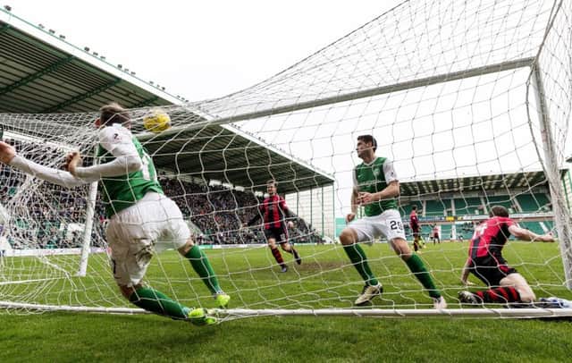 Martin Boyle falls into the net after scoring Hibs' second equaliser to make it 2-2