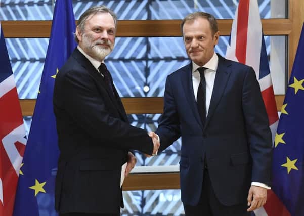EU Council President Donald Tusk with UK Permanent Representative to the EU Tim Barrow handing Theresa May's formal notice to leave the EU. Picture; AP