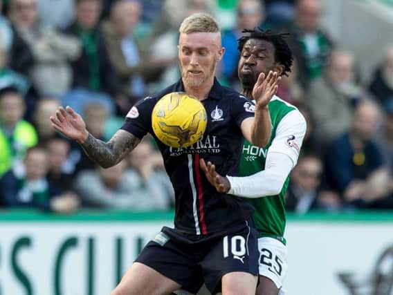 Hibs defender Efe Ambrose battles with Falkirk's Craig Sibbald for the ball at Easter Road this afternoon, the two were later to score for their respective sides