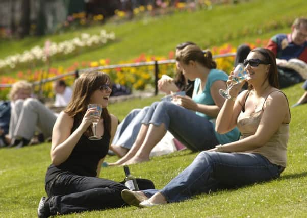 Revellers enjoy the sunshine in Princes St Gardens. Picture: Phil Wilkinson