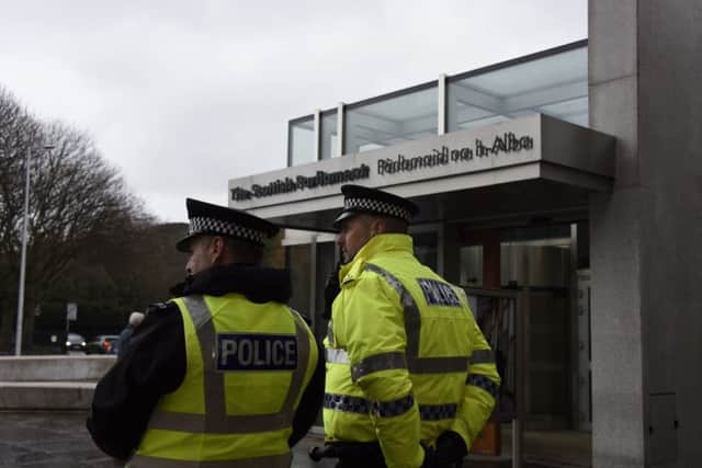 Police stand guard outside the Scottish Parliament and the Palace of Holyrood House following a terrorist incident in Westminster. Picture: JP License.