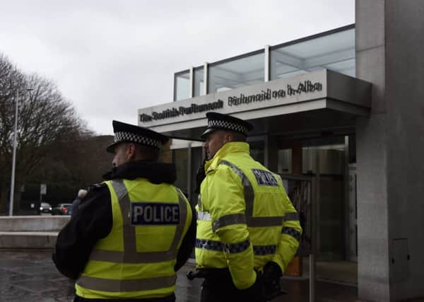 Police stand guard outside the Scottish Parliament and the Palace of Holyrood House following a terrorist incident in Westminster. Picture: JP License.