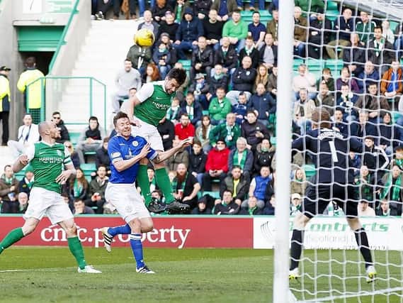 Darren McGregor leaps above everyone to give Hibs the lead against Queen of the South at Easter Road