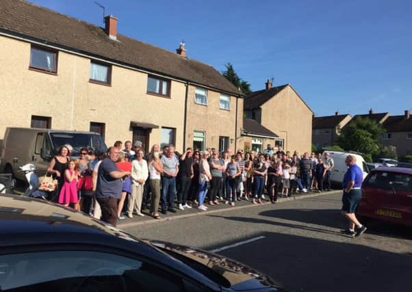 Locals in Pathhead gathering outside the home where convicted rapist Robert Greens was expected of being moved to last year.