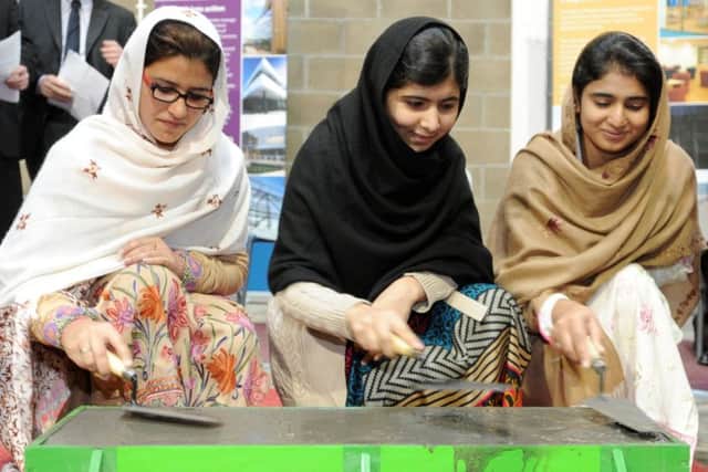 Malala Yousafzai (centre) with Kainat Riaz (left) and Shazia Ramzan, pictured in 2013. Picture: Jane Barlow