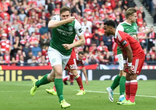 Grant Holt celebrates after his first-half header  brought Hibs back into the semi-final, main picture