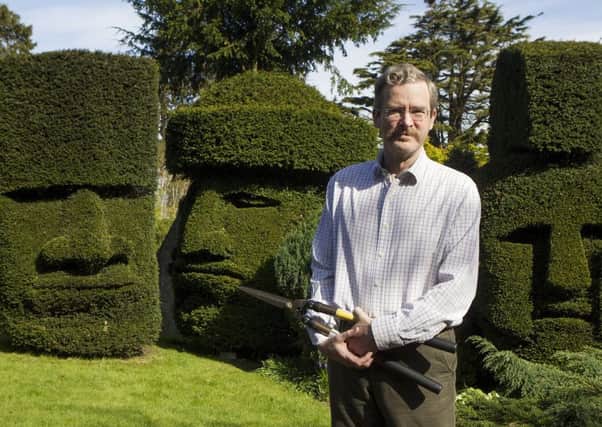 Three topiary heads created by Michael Kaplan in his garden. Picture: SWNS