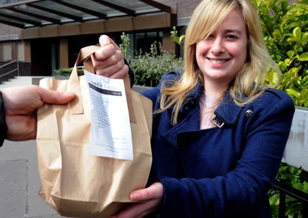 Evening News Reporter Fiona Pringle takes delivery of her food as she tries out the new UberEats service. Picture: Lisa Ferguson