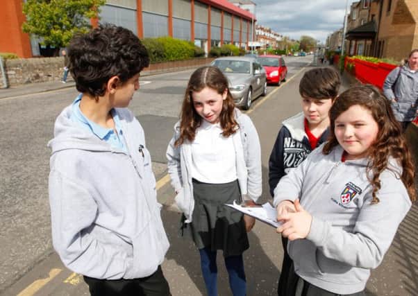 Children from Flora Stevenson Primary School undertake a survey  to see how many cars park on the single yellow line outside the school.