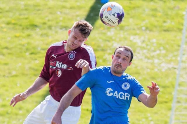 Linlithgow Rose's Gary Thom, left, battles with Musselburgh's Mathu King. Pic: Ian Georgeson