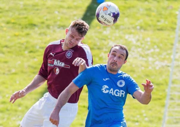 Linlithgow Rose's Gary Thom, left, battles with Musselburgh's Mathu King. Pic: Ian Georgeson