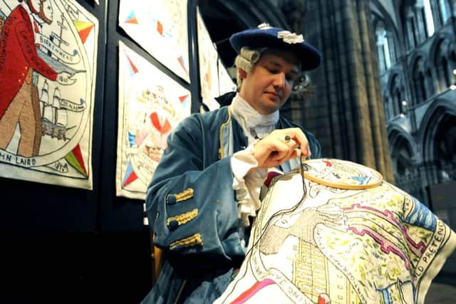 Aaron Johnston sews the tapestry he made. Picture: Lisa Ferguson