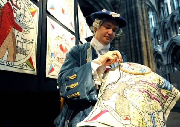 Aaron Johnston sews the tapestry he made. Picture: Lisa Ferguson